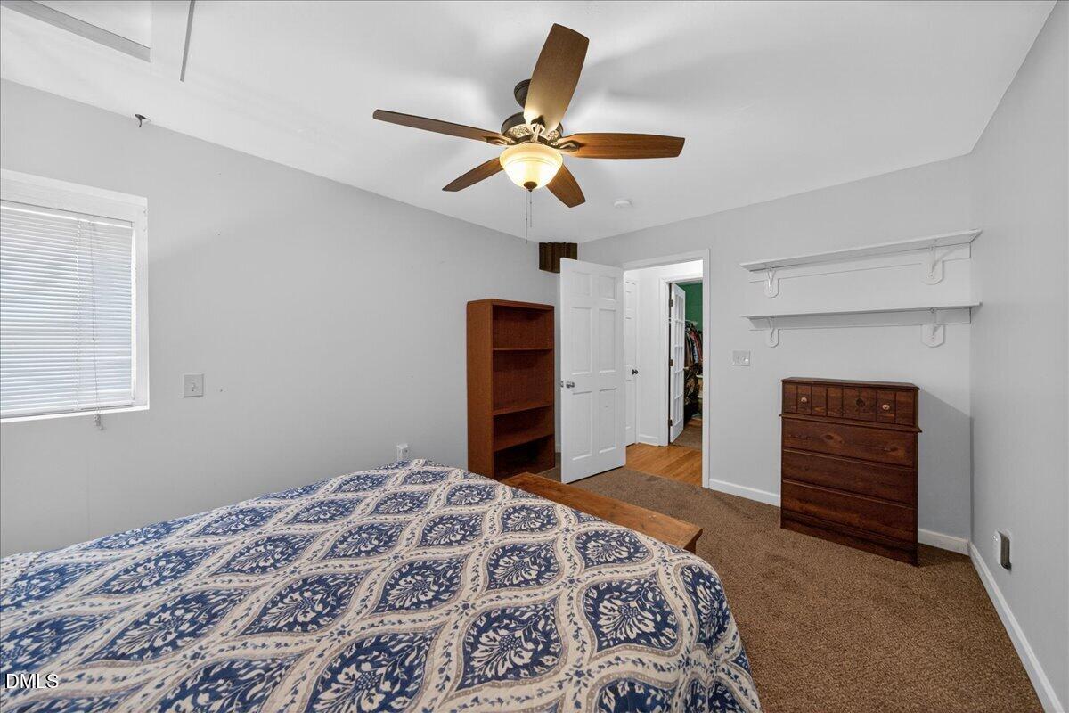 7303 Stony Hill Road Wake Forest, NC 27587 - Photo 24 of 31 a bedroom with a bed and a dresser