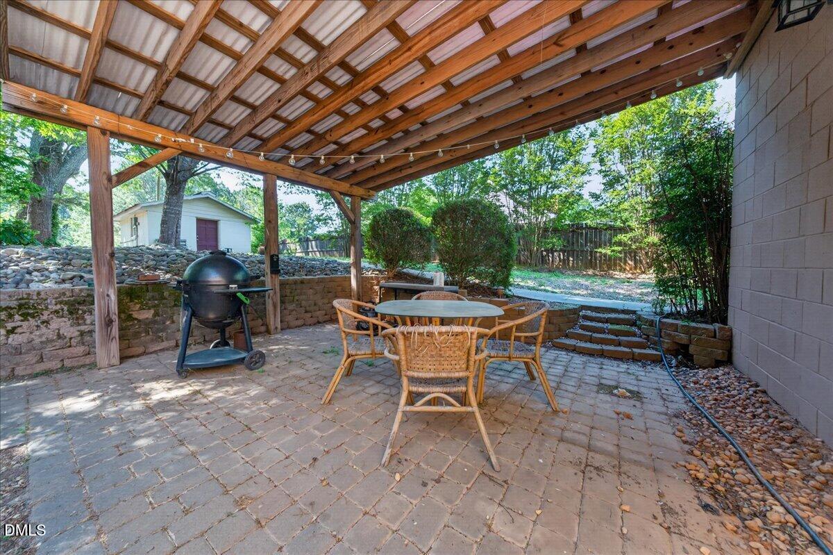 7303 Stony Hill Road Wake Forest, NC 27587 - Photo 27 of 31 a view of a patio with table and chairs and wooden floor