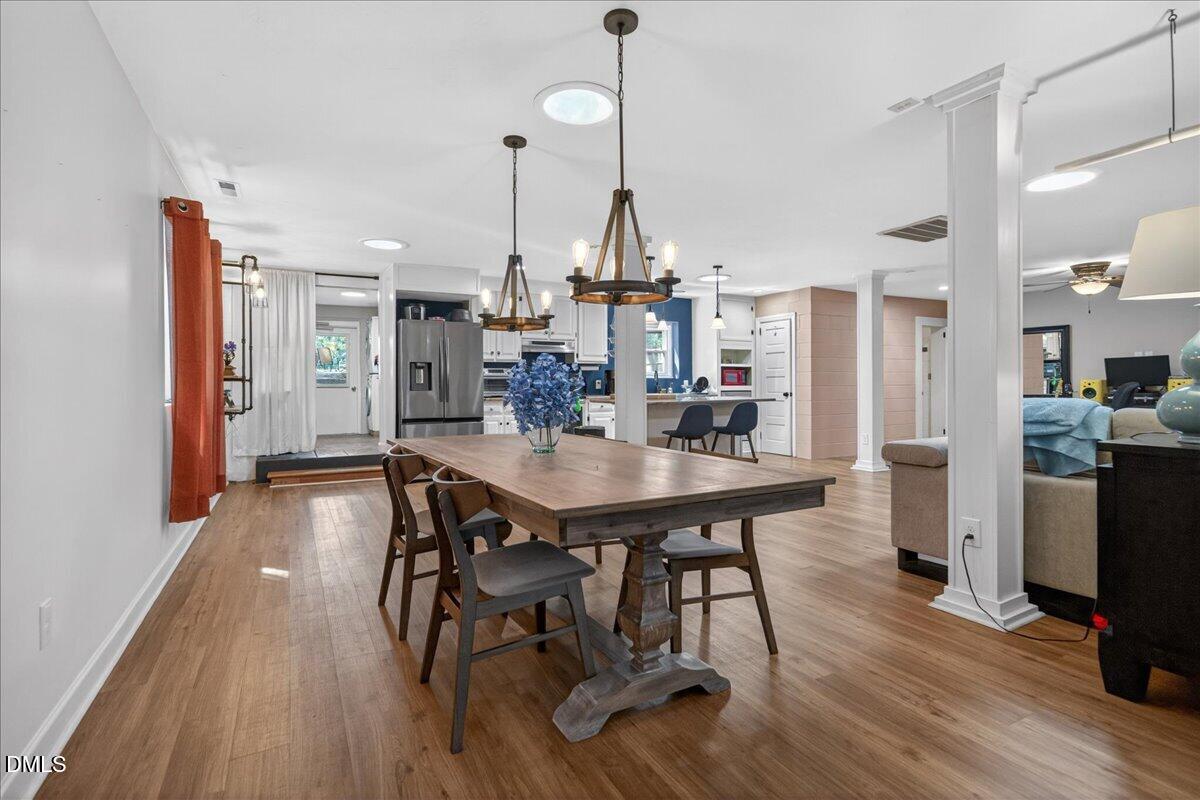 7303 Stony Hill Road Wake Forest, NC 27587 - Photo 8 of 31 a dining room filled with furniture and wooden floor