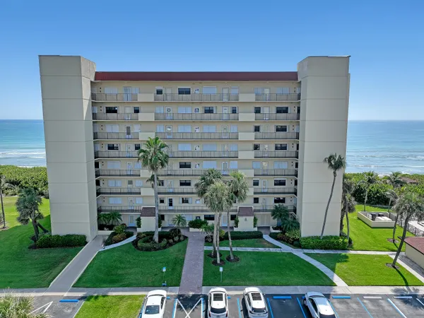 a view of a tall building with a yard