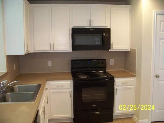 a kitchen with a stove and a microwave