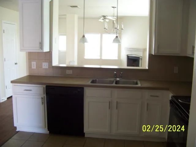 a kitchen with a sink and a window