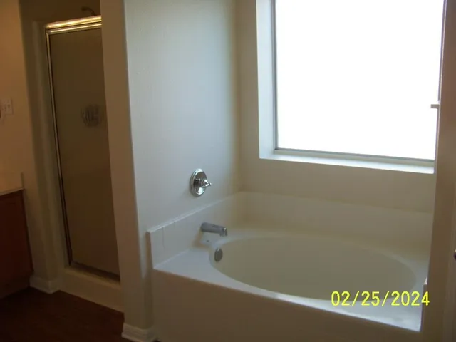a white bath tub sitting next to a window