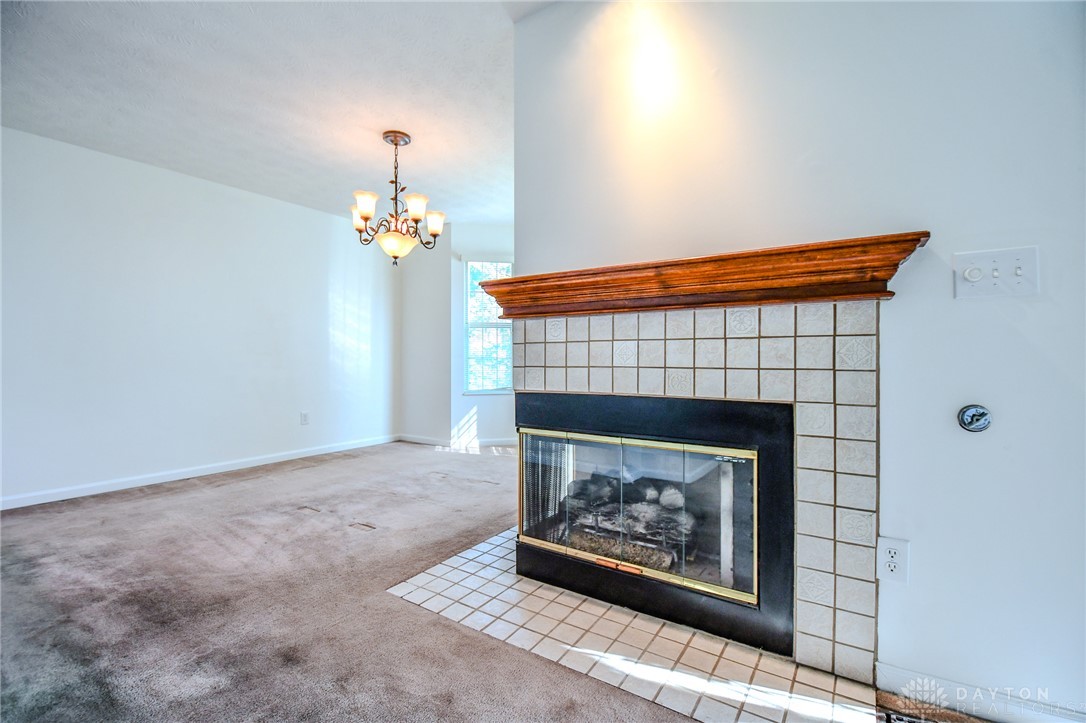 3915 East Summit Ridge Drive Beavercreek, OH 45430 - Photo 9 of 47 This inviting space features a charming fireplace, perfect for cozy gatherings and relaxed living.