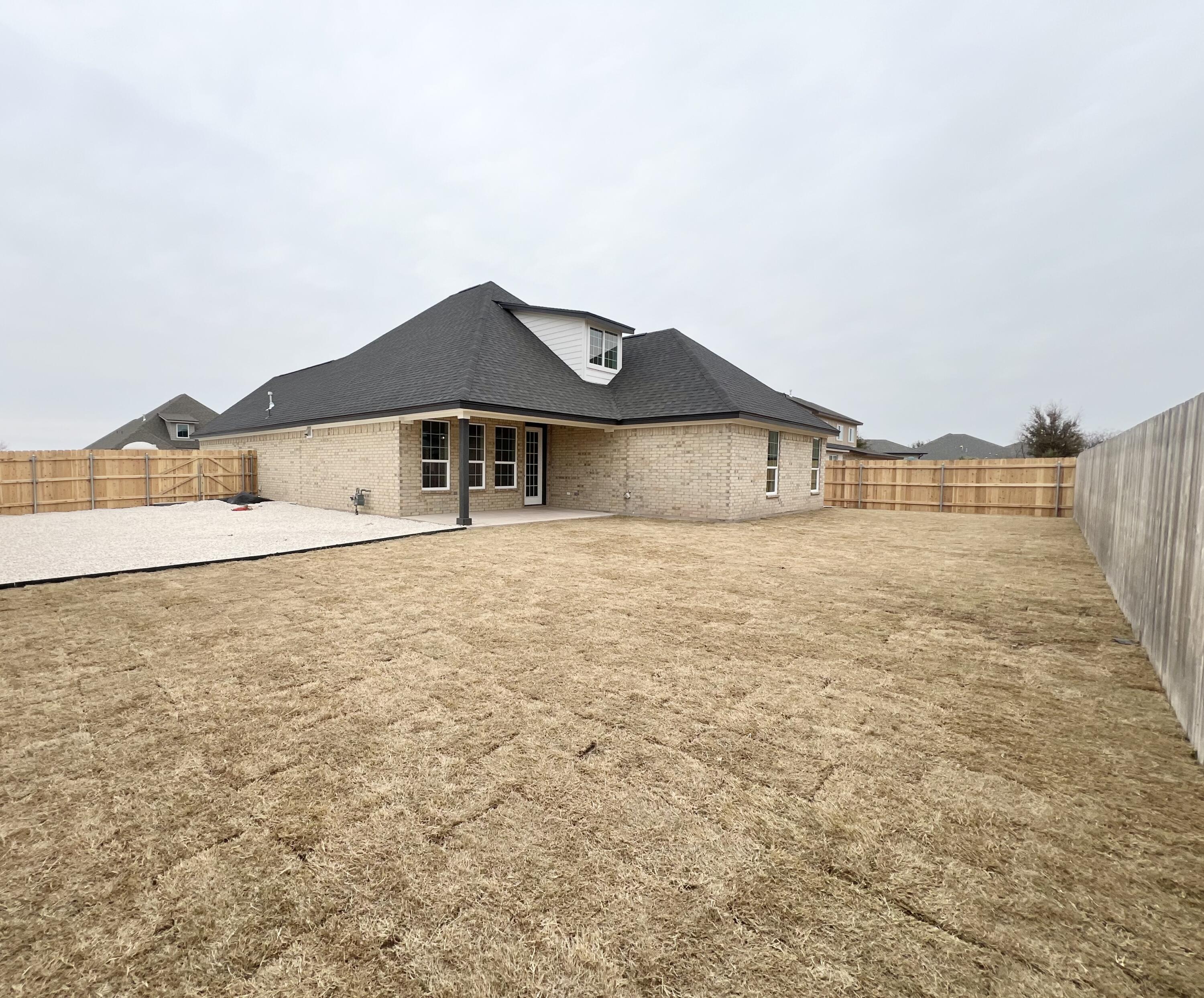 1974 Beaty Road San Angelo, TX 76904 - Photo 33 of 34 Large fully fenced backyard with covered patio and additional parking in gravel area next to the house