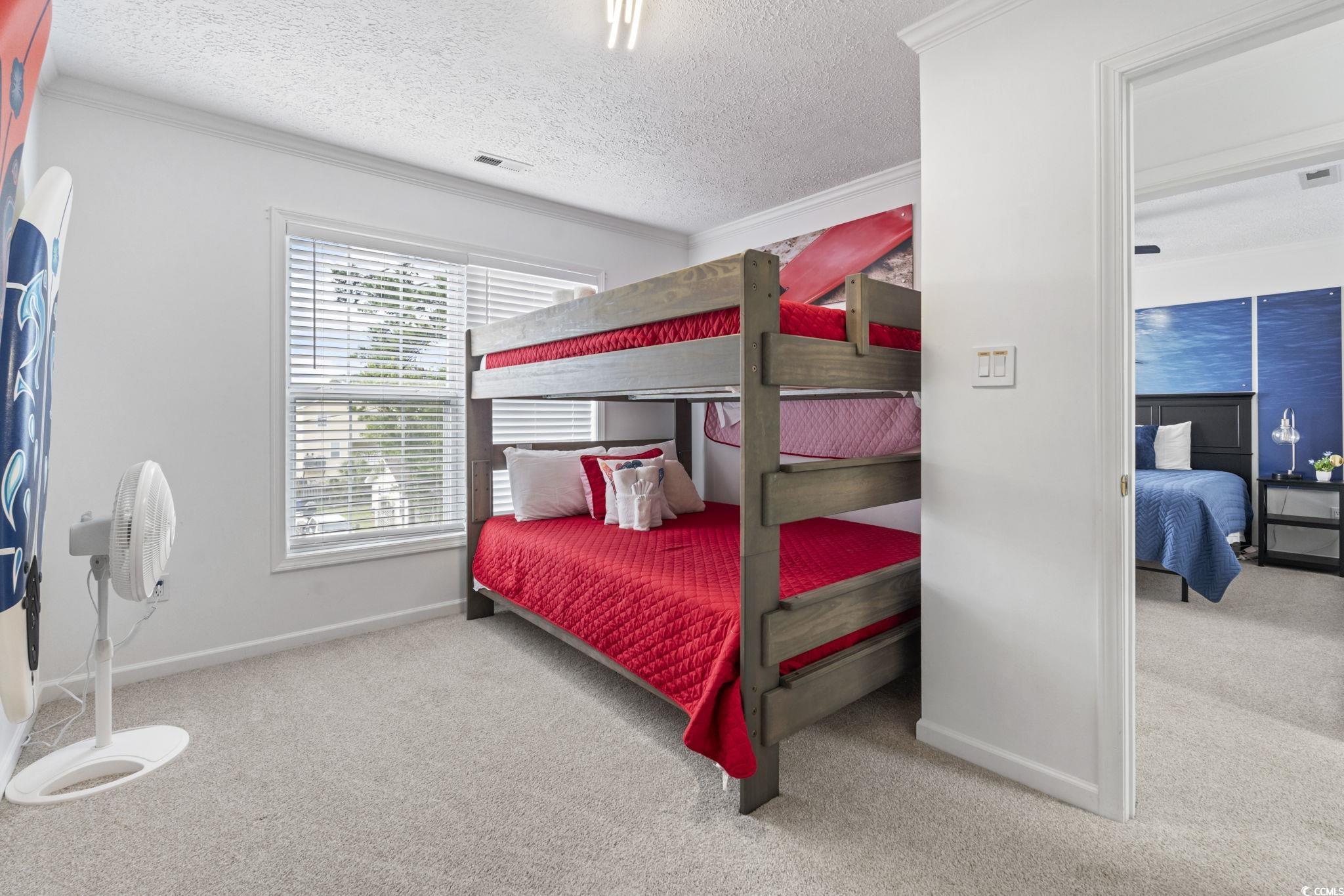 327 A Lakeside Drive Surfside Beach, SC 29575 - Photo 17 of 40 Bedroom with carpet floors, ornamental molding, baseboards, and a textured ceiling