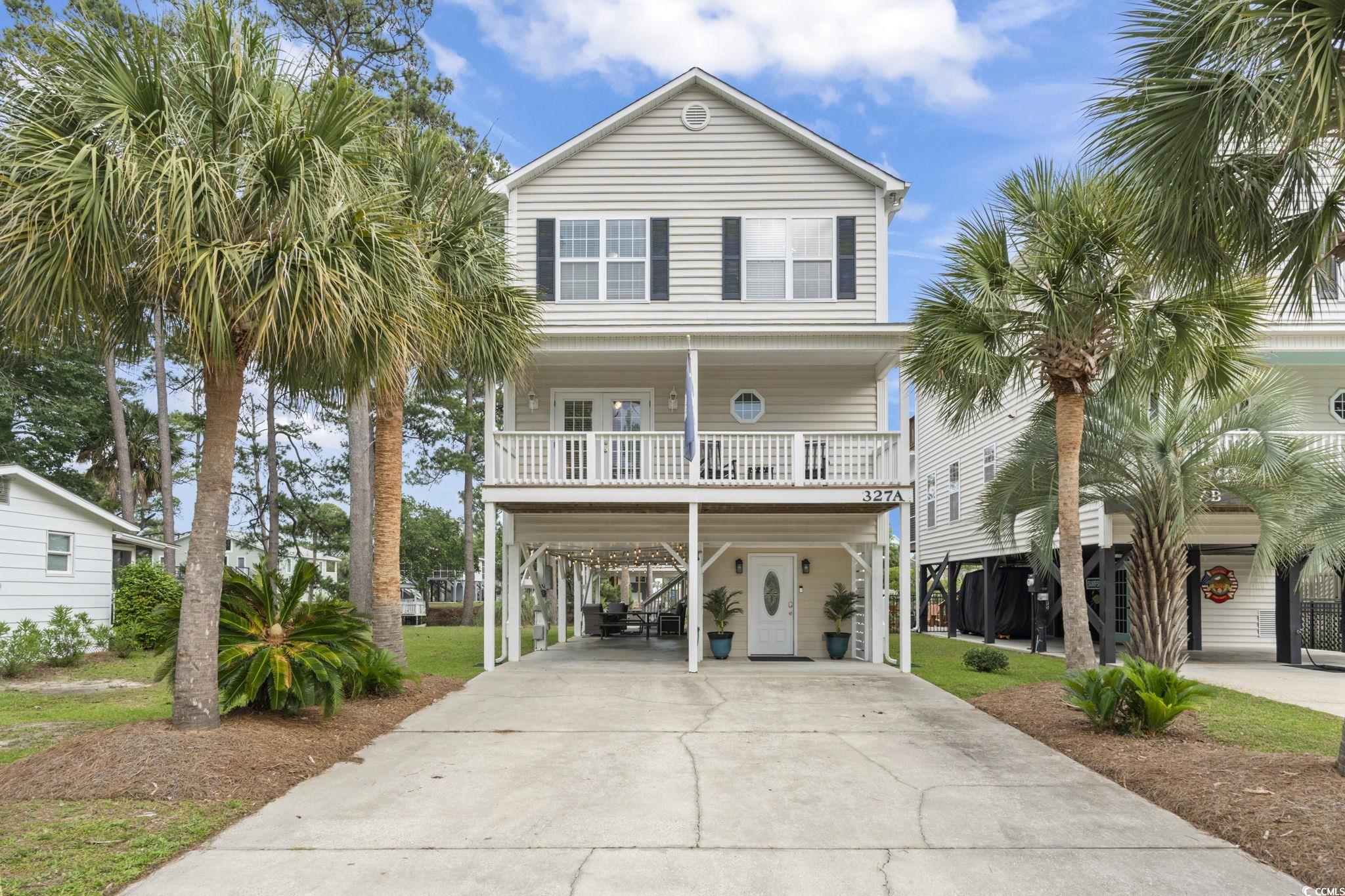 327 A Lakeside Drive Surfside Beach, SC 29575 - Photo 2 of 40 Coastal inspired home with a carport, driveway, and covered porch