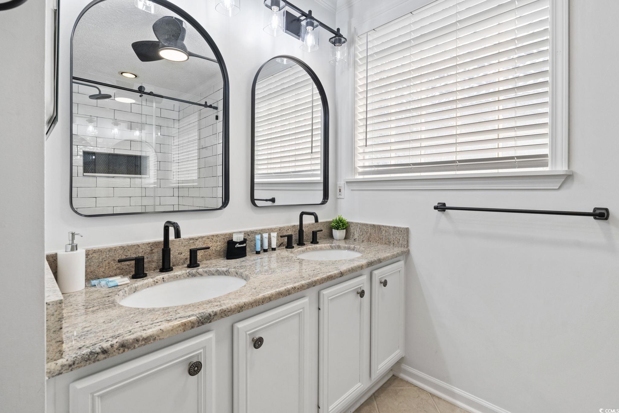 327 A Lakeside Drive Surfside Beach, SC 29575 - Photo 21 of 40 Bathroom featuring tiled shower, double vanity, and tile patterned floors
