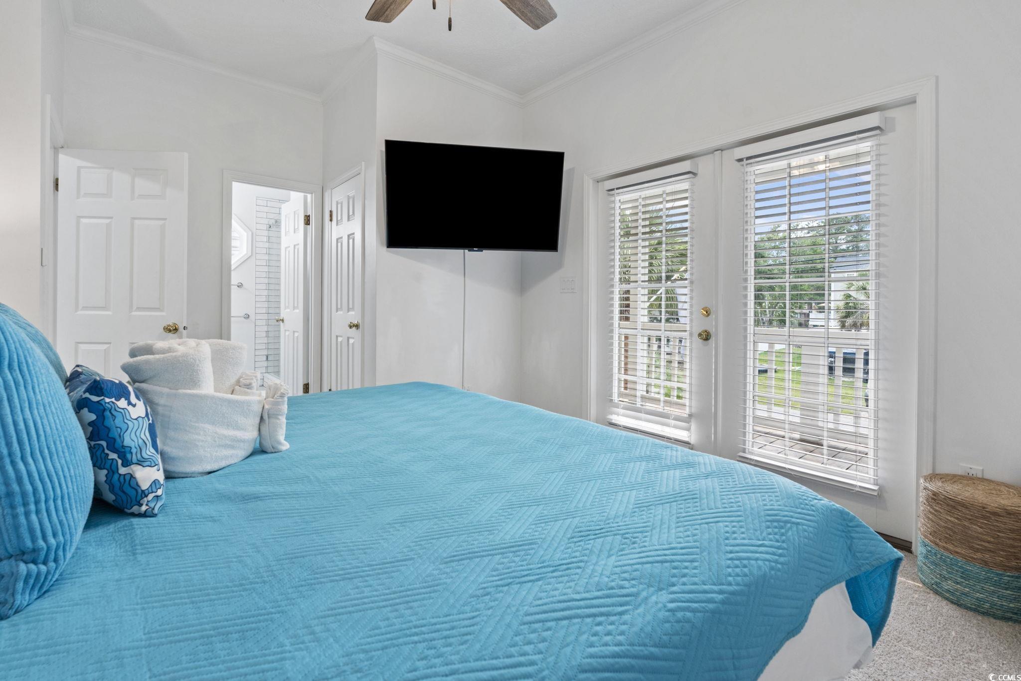 327 A Lakeside Drive Surfside Beach, SC 29575 - Photo 25 of 40 Carpeted bedroom featuring access to outside, crown molding, a ceiling fan, connected bathroom, and french doors