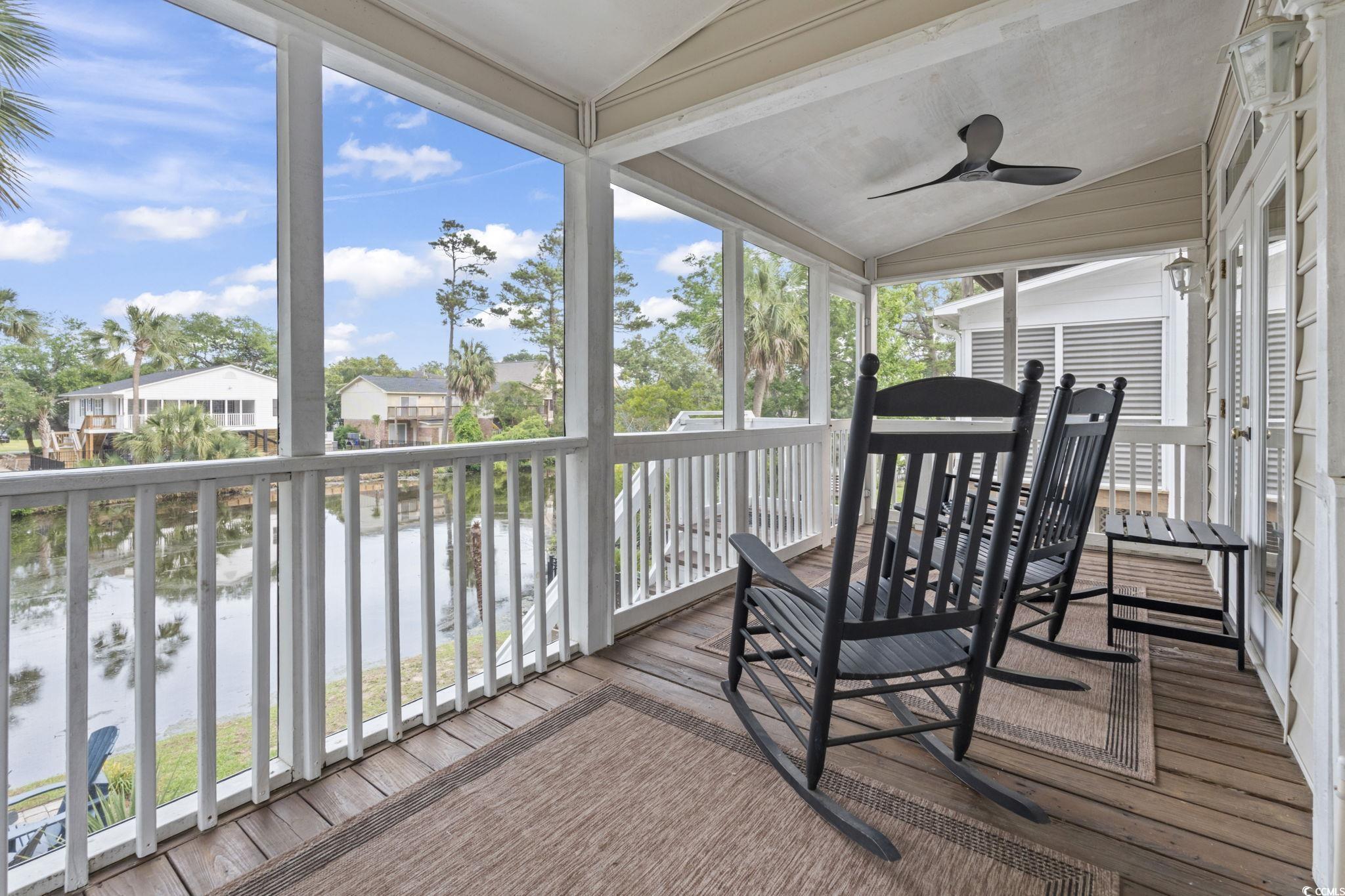 327 A Lakeside Drive Surfside Beach, SC 29575 - Photo 32 of 40 Sunroom / solarium with lofted ceiling, ceiling fan, a water view, and healthy amount of natural light