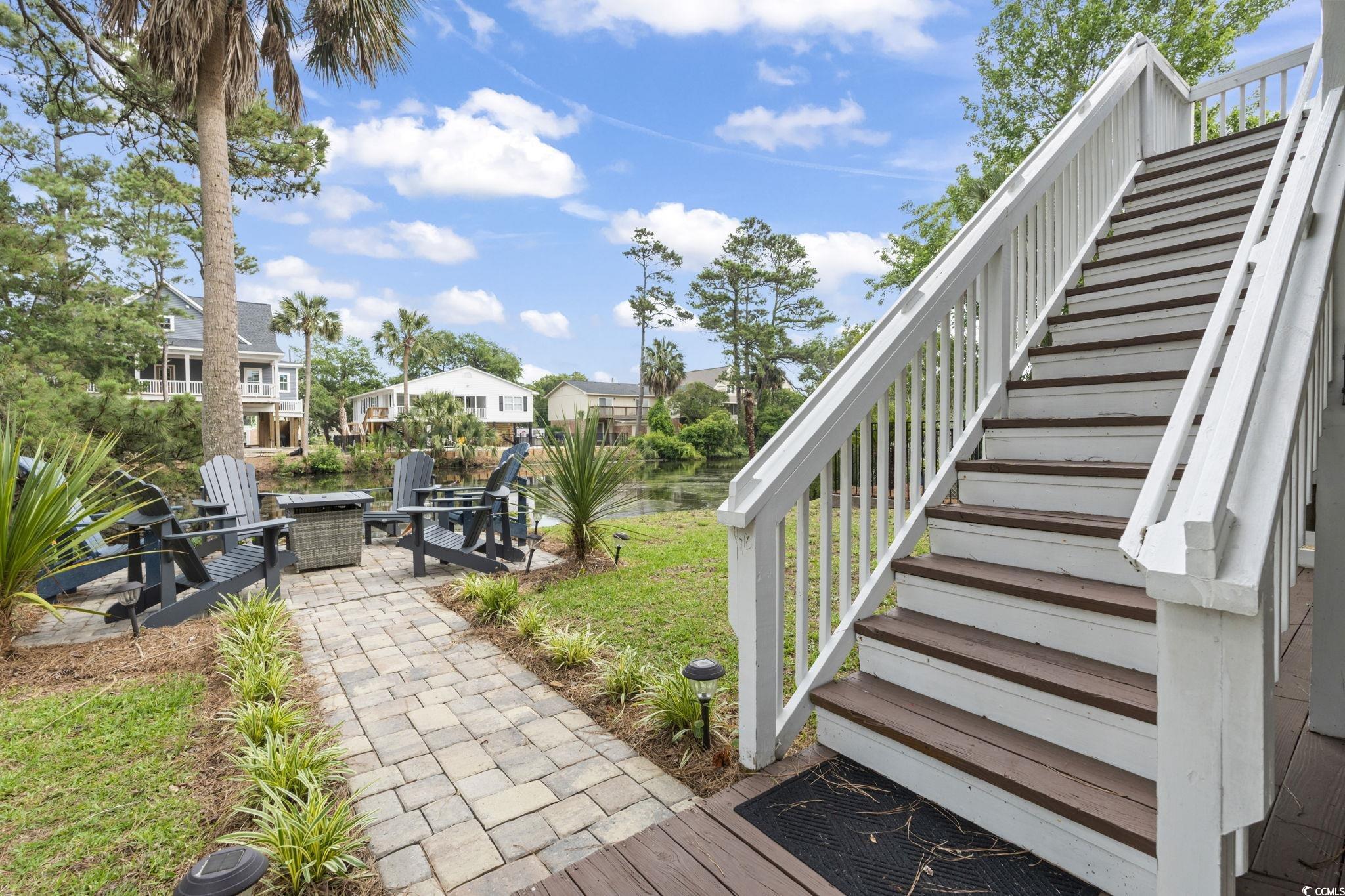 327 A Lakeside Drive Surfside Beach, SC 29575 - Photo 34 of 40 View of yard featuring stairway, a fire pit, a patio area, and a residential view
