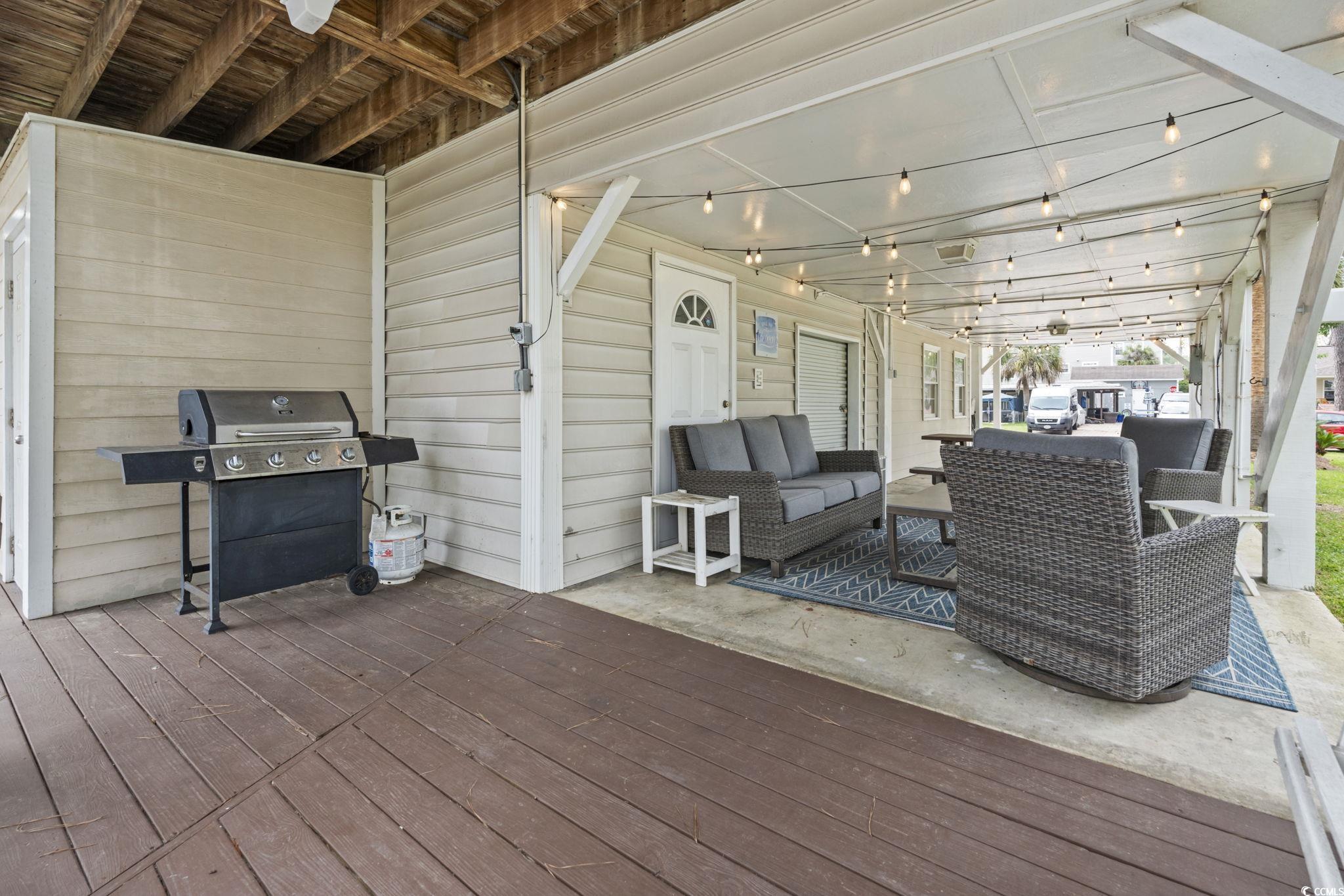 327 A Lakeside Drive Surfside Beach, SC 29575 - Photo 5 of 40 Wooden deck with area for grilling and an outdoor living space