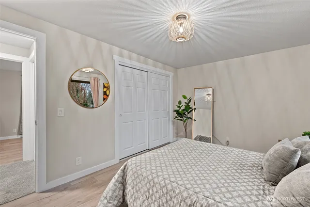 a bedroom with a bed and a chandelier