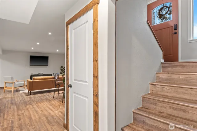 a view of an entryway with wooden floor