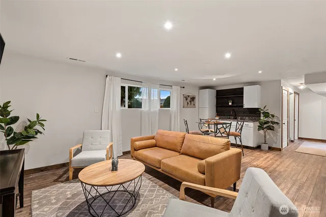 a living room with furniture kitchen view and a table