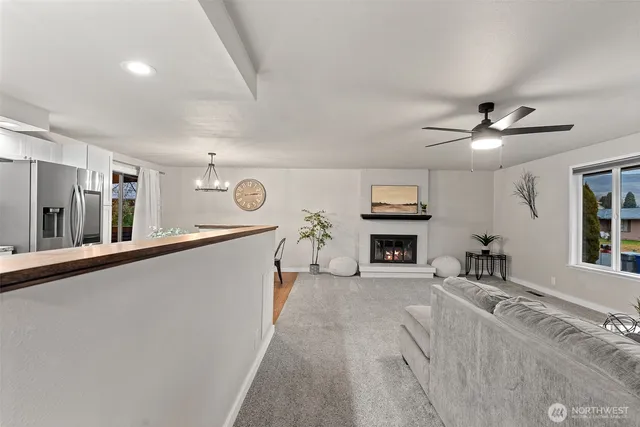 a living room with fireplace furniture and a window