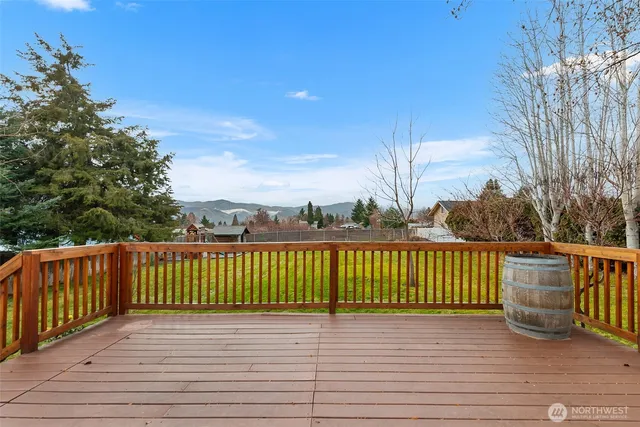 a view of a deck with wooden floor and fence