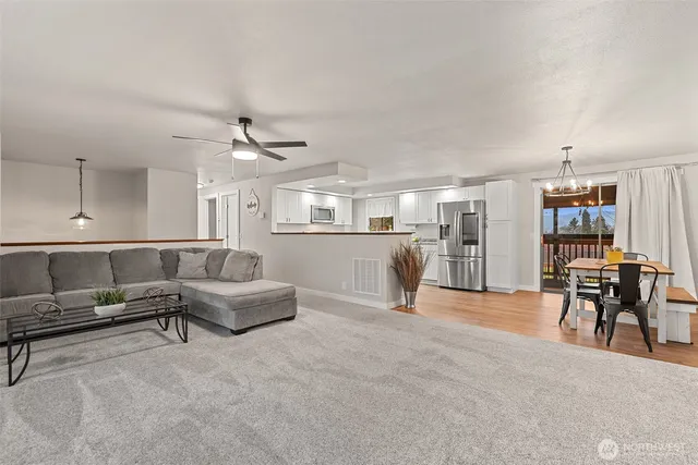 a living room with furniture and kitchen view
