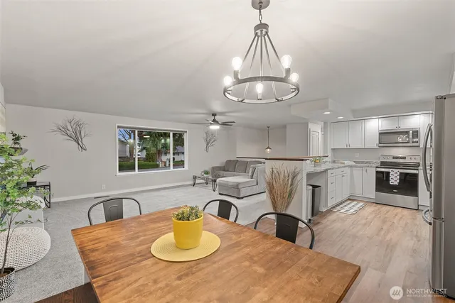 a view of a dining room with furniture and a chandelier