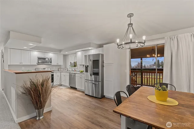 a kitchen with refrigerator and cabinets