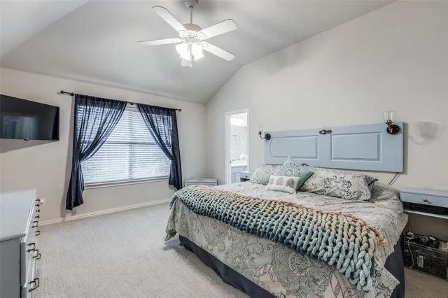 a bedroom with a large bed and a window