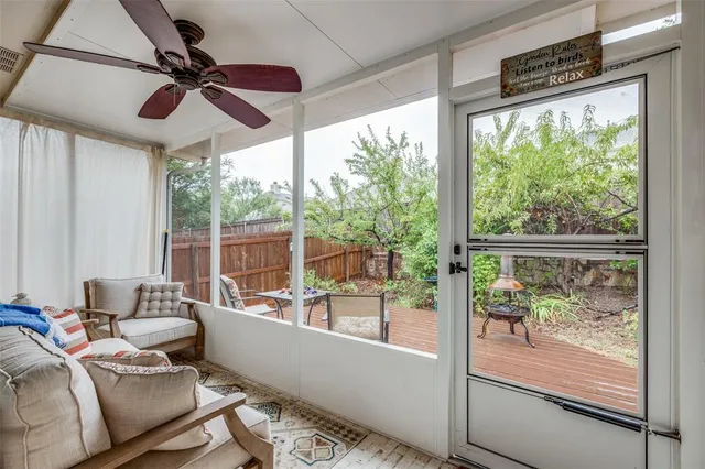 a view of a patio with dining table and chairs with wooden floor