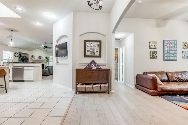 a living room with furniture and a wooden floor