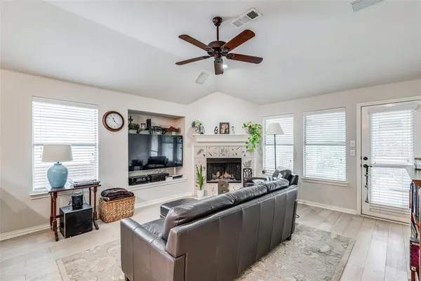 a living room with furniture fireplace and a window