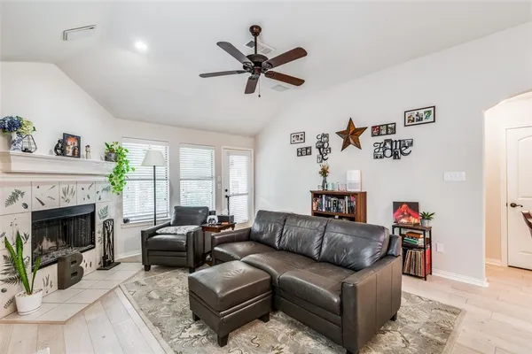 a living room with furniture fireplace and a window