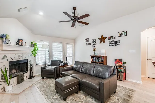 a living room with furniture fireplace and a window