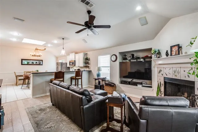 a living room with furniture a fireplace and a flat screen tv
