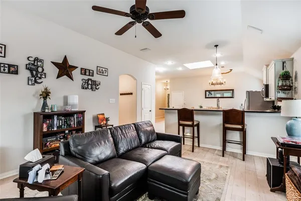 a living room with furniture a ceiling fan and a rug