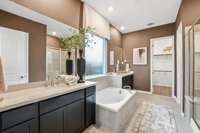 a living room with furniture kitchen view and a chandelier