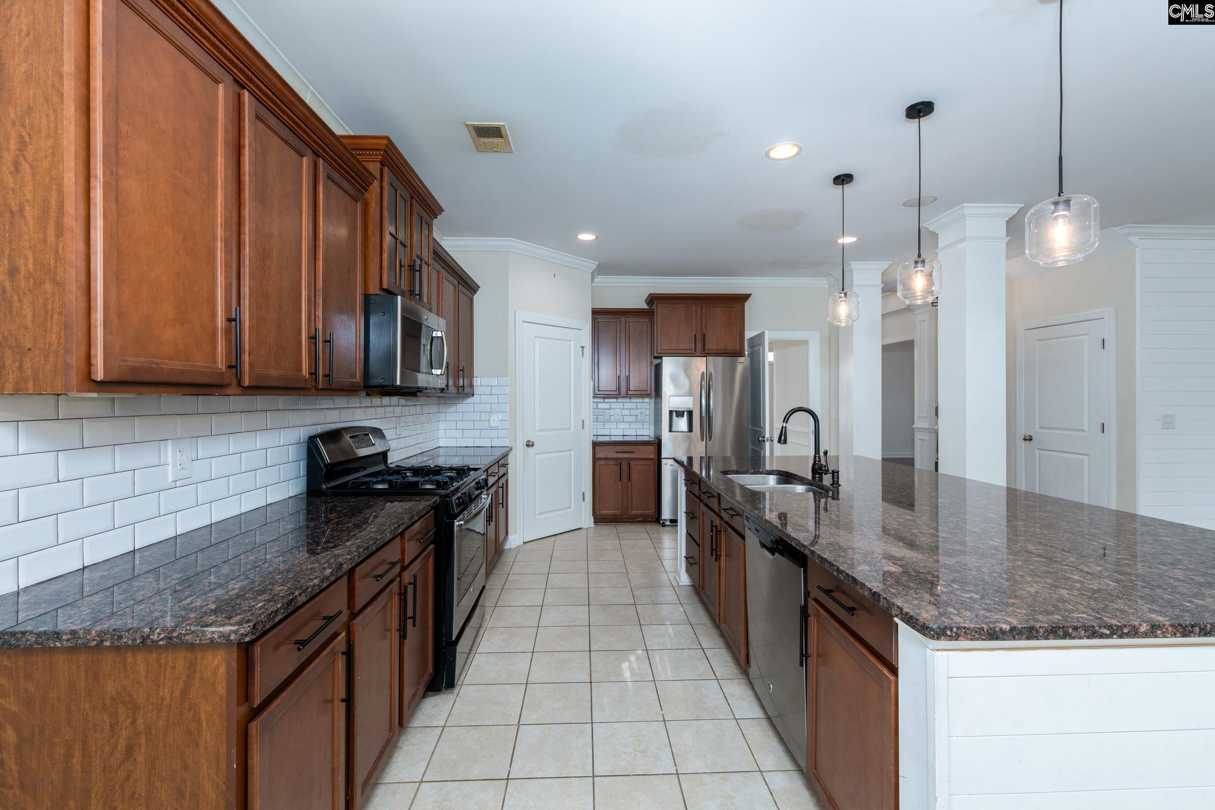 40 Wading Bird Loop Blythewood, SC 29016 - Photo 5 of 26 a kitchen with granite countertop stainless steel appliances a sink dishwasher a refrigerator oven and a counter top space