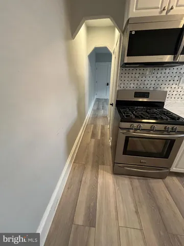 a stove top oven sitting inside of a kitchen