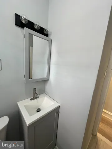 a bathroom with a sink toilet and mirror