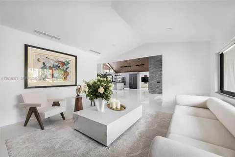 a living room with furniture and a painting on the wall