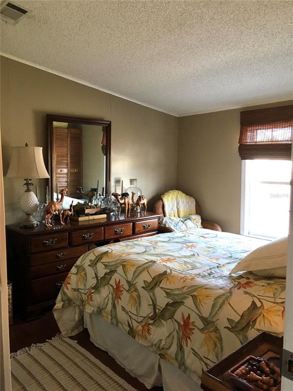 1297 Pfundstein Road Babson Park, FL 33827 - Photo 26 of 65 a bedroom with a bed and wooden floor