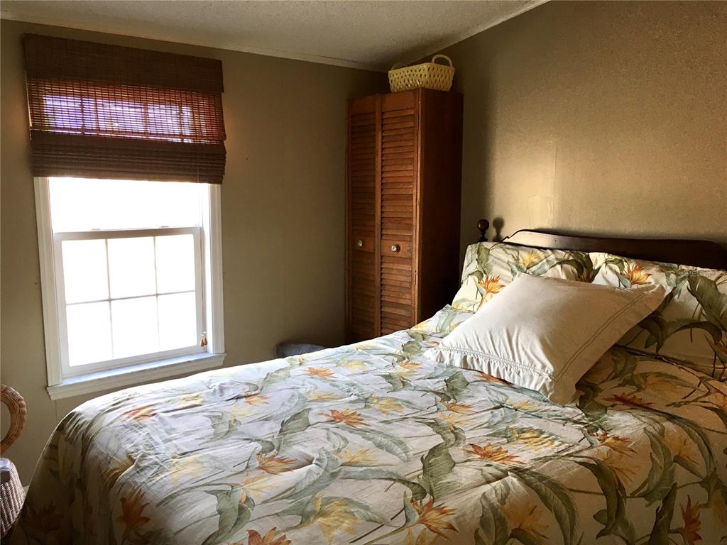 1297 Pfundstein Road Babson Park, FL 33827 - Photo 27 of 65 a bedroom with a bed and a window
