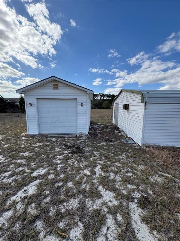 1297 Pfundstein Road Babson Park, FL 33827 - Photo 36 of 65 a view of a house with a yard and garage