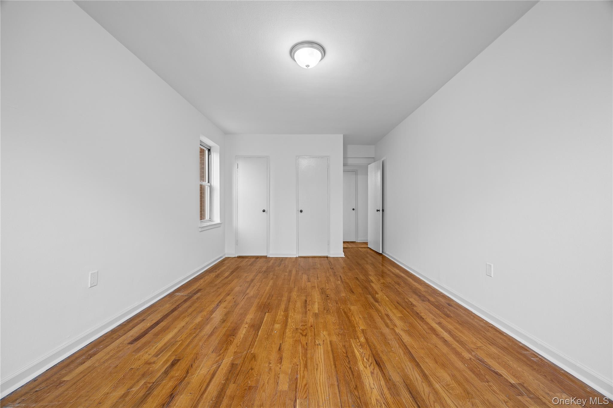 255 Bronx River Road, Unit 4M Yonkers, NY 10704 - Photo 15 of 19 a view of empty room with wooden floor