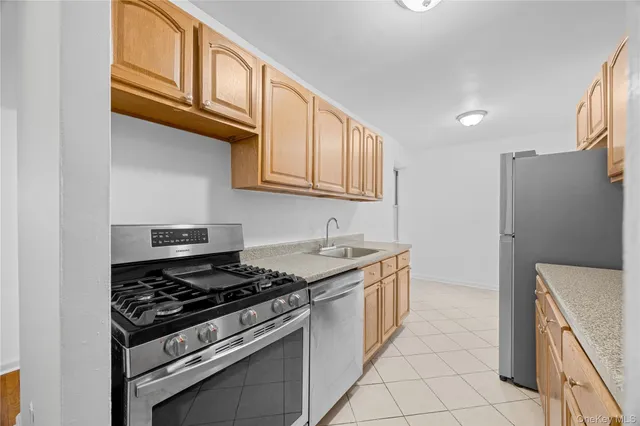 a kitchen with stainless steel appliances granite countertop a stove and a refrigerator