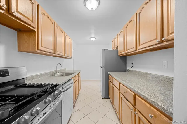 a kitchen with stainless steel appliances granite countertop a stove and a sink