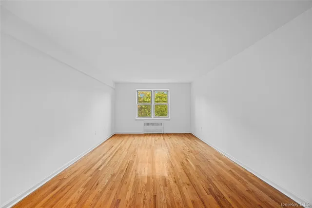 a view of room with window and hardwood floor