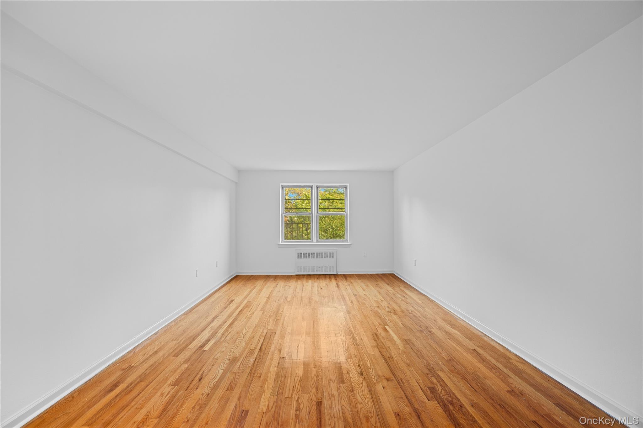 255 Bronx River Road, Unit 4M Yonkers, NY 10704 - Photo 10 of 19 a view of room with window and hardwood floor