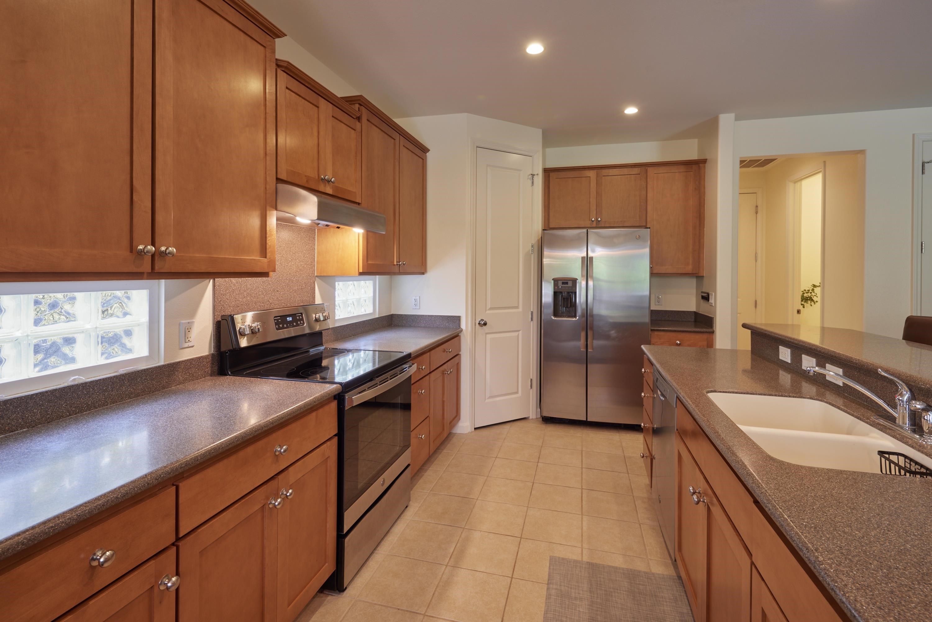 133 Kinohi Loa Loop Wailuku, HI 96793 - Photo 25 of 45 a kitchen with stainless steel appliances granite countertop a sink refrigerator and cabinets
