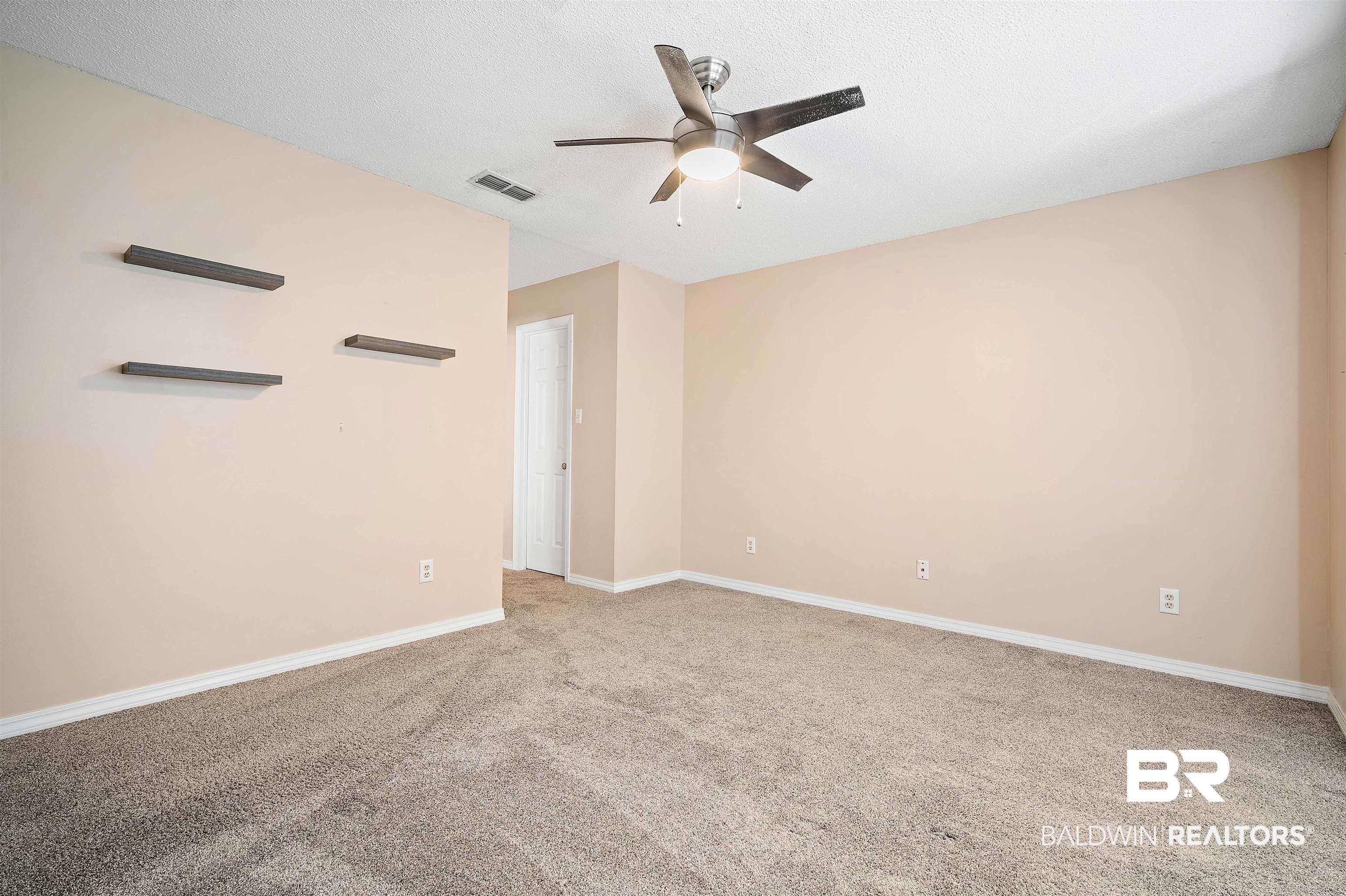 804 Wildwood Avenue Mobile, AL 36609 - Photo 18 of 30 Primary bedroom featuring ceiling fan, light carpet, and a textured ceiling