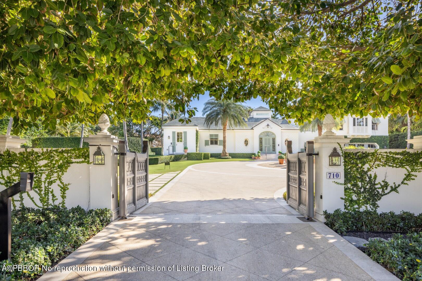 710 South County Road Palm Beach, FL 33480 - Photo 1 of 69 a front view of a house with a yard and tree