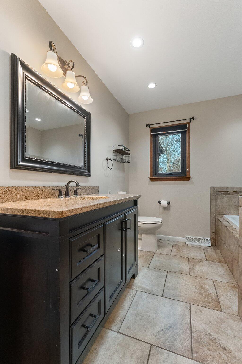 12163 North 900 West Demotte, IN 46310 - Photo 14 of 23 a bathroom with a toilet sink and mirror