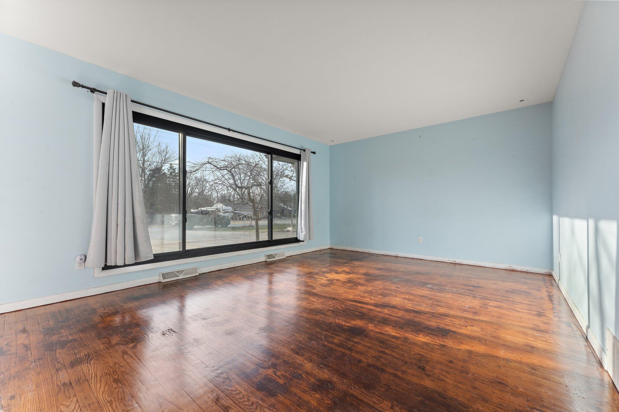 12163 North 900 West Demotte, IN 46310 - Photo 5 of 23 a view of an empty room with wooden floor and a window